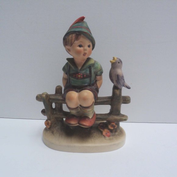 hummel boy on fence with bird